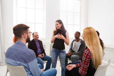 adult woman standing infront of other people