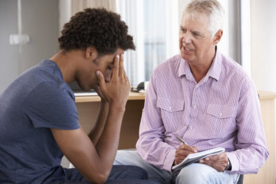 young man talking to a counselor