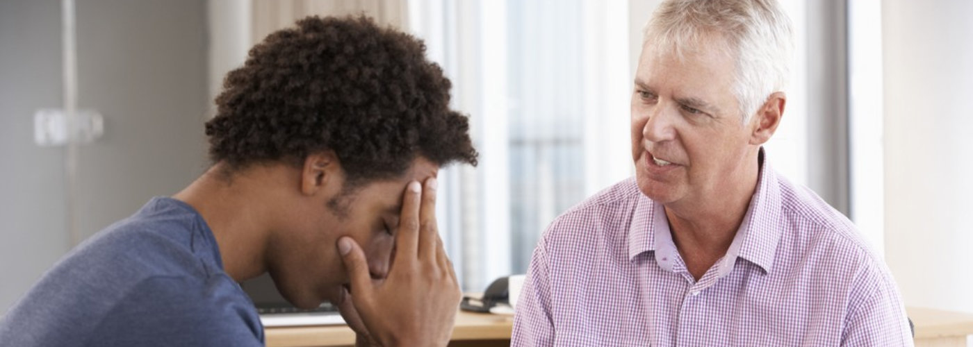 young man talking to a counselor